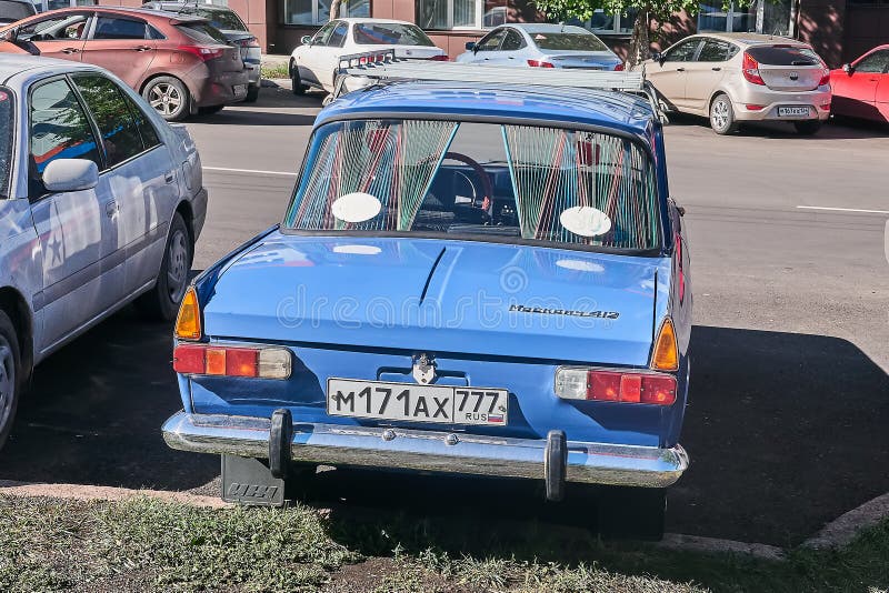 izh-moskvich-rear-krasnoyarsk-russia-september-car-parked-near-new-working-building-view-125658081